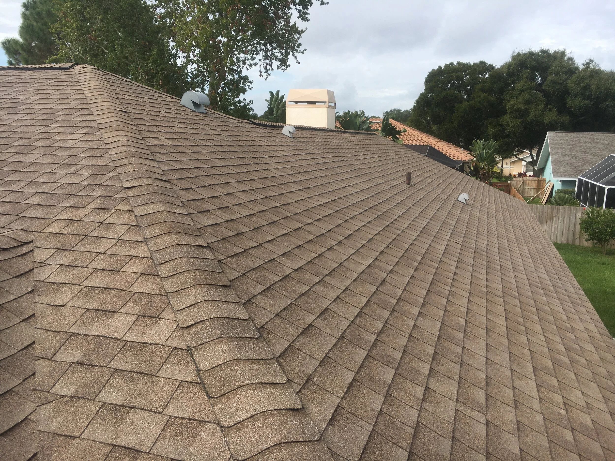 The same shingle roof after a soft wash with an even, clean surface