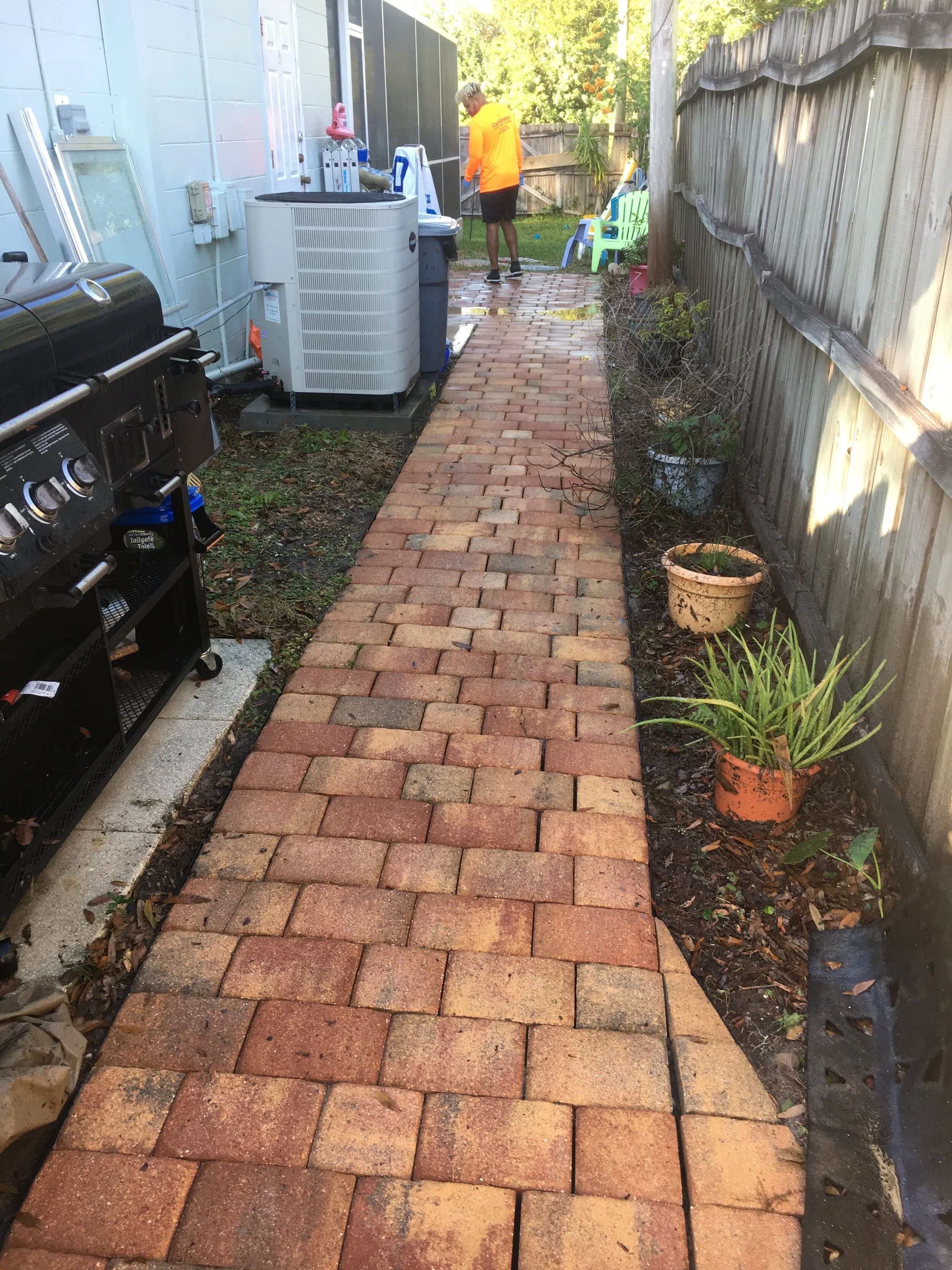 The same paver walkway after cleaning with the red paver color restored